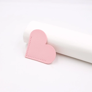 Pink heart-shaped leather bookmark with lychee texture and precision stitching