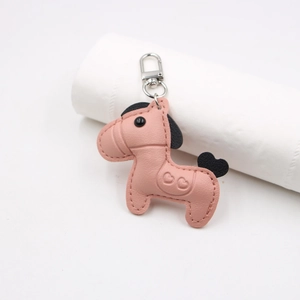 Pink leather pony bag charm with lychee texture and silver heart engraved keychain