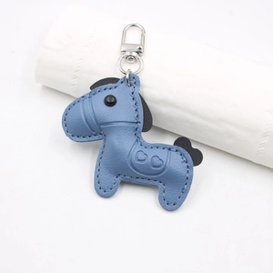 Macro shot of Morandi blue lychee pattern leather pony charm with hand-stitched detailing