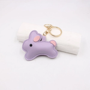 Detail of purple PU leather bunny bag charm with golden lobster clasp and stitching