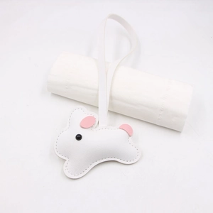 Close-up of white leather rabbit bag charm with pink details and neat stitching