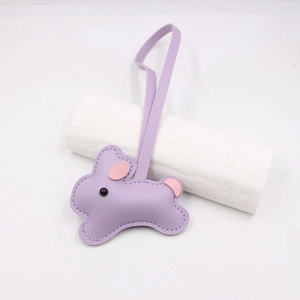 Close-up of a cute purple leather bunny bag charm with fine stitching and long strap