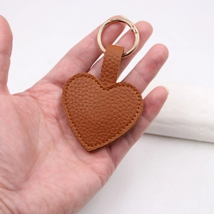 Brown litchi grain PU leather heart keychain with golden circular spring clasp clip