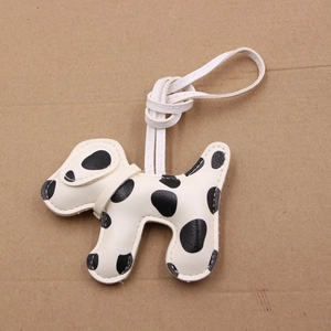 Creative Dalmatian dog faux leather keychain with black spots and white stitching detail