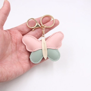 Pink and mint green butterfly leather keychain with golden ring and white stitching