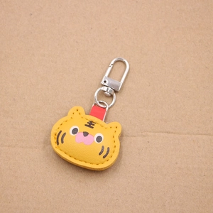 Cartoon tiger leather keychain with yellow stitching and metal spring hook fastener