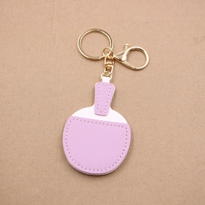 Detailed view of lavender leather ping pong paddle keychain with gold metal clasp