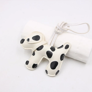 Creative spotted dog leather keychain with lanyard and black dots on off-white texture