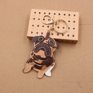 Handcrafted pug leather keychain with golden clasp and brown patchwork textures