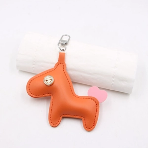 Porte-clés cheval en cuir orange avec logo dollar en strass et fermoir en métal argenté