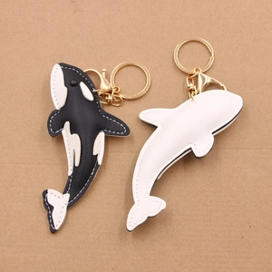 Shark skin textured leather keychain charms with dolphin and orca shapes and golden hooks