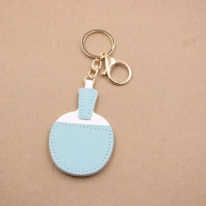Light blue and white faux leather table tennis paddle keychain with gold metal ring hardware
