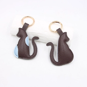 Set of two cute cat-shaped PU leather keychains in dark brown and light blue finish