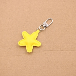 Mini yellow star leather pendant charm with silver spring clasp and detailed hand stitching