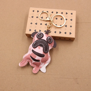 Detailed macro view of pink camo leather pug keychain with golden metal clasp