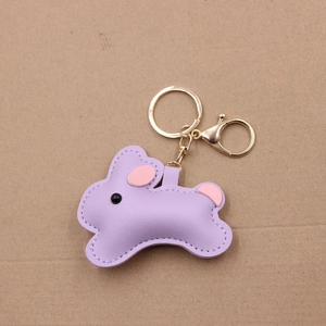 Detail of purple leather bunny keychain with gold lobster clasp and white stitching detail