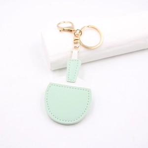 Detail of leather table tennis paddle keychain with mint green finish and gold lobster clasp