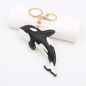 Orca shark leather keychain with black and white pebble texture and gold lobster clasp