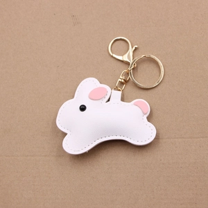 Detail of cute white leather cartoon rabbit keychain with pink accents and golden clasp
