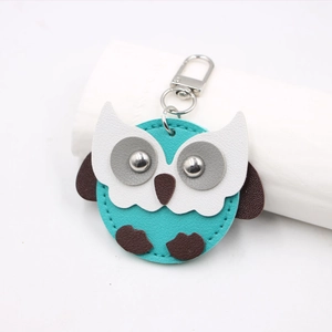 Blue leather owl keychain charm with silver metal rivet eyes and a spring clasp