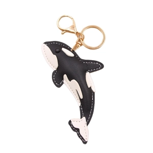 Orca shark shaped leather keychain with white contrast stitching and gold metal hardware