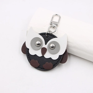 Detailed view of handmade owl leather keychain with silver metal lobster clasp and D-ring