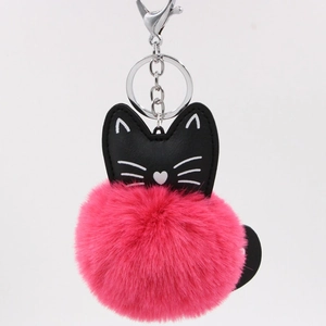 Close-up of rose red faux fur pompom keychain with a black PU leather cat head detail