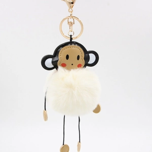 Cute monkey plush keychain with fluffy beige faux fur pompom and golden swivel hook
