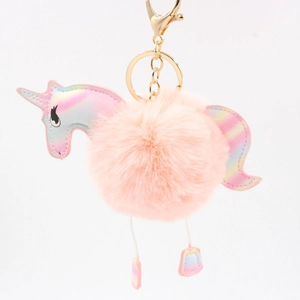 Detail of pink faux fur unicorn keychain with iridescent laser material and golden clasp