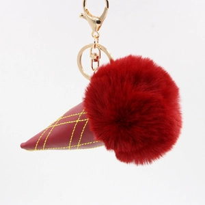 Detail of red faux fur ice cream keychain with synthetic leather cone and gold clasp