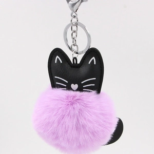 Detail of cute cat faux leather charm with fluffy purple pom pom and silver clasp