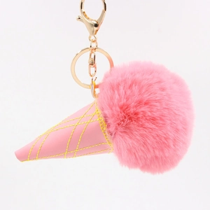 Close-up of pink faux fur ice cream cone keychain with gold lobster clasp and leather detail