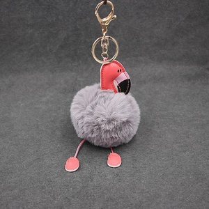 Détail du porte-clés flamant rose en fourrure avec tête en cuir et fermoir doré