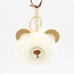 Detailed view of the cute beige faux fur bear keychain with a golden lobster clasp hook