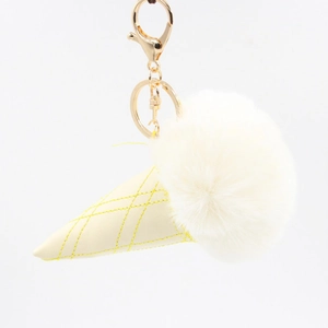 Detailed view of ice cream keychain with fluffy white faux fur and yellow leather cone