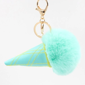 Detail of mint green ice cream pompom keychain with leather cone and golden lobster clasp