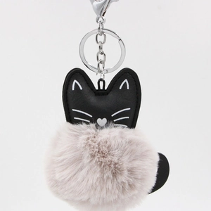 Close-up of black PU leather cat keychain with a soft light purple faux fur pompom