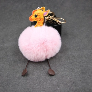 Detailed view of pink faux fur giraffe keychain with gold metal clasp and leather details