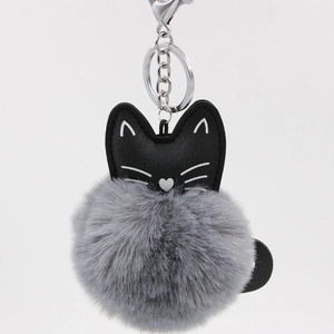 Detail of grey fluffy faux fur pompom keychain with black PU leather cat head and silver clasp