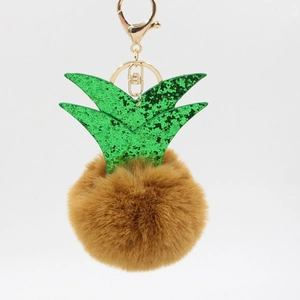 Detail of pineapple plush keychain with faux fur ball and sparkling green sequin leaves