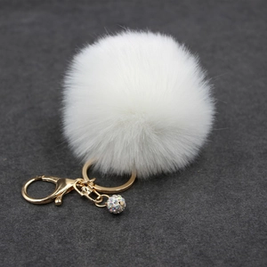 White faux fur pom pom keychain with gold lobster clasp and sparkling rhinestone ball pendant