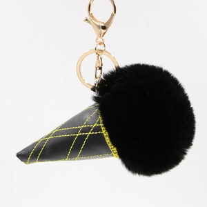 Detail shot of ice cream keychain with black faux fur ball and gold lobster clasp