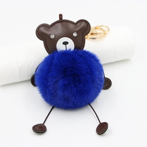 Detail of royal blue faux fur pompom bear keychain with leather head and crystal eyes