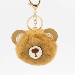 Detail of cute brown faux fur bear keychain with golden metal lobster clasp and ring