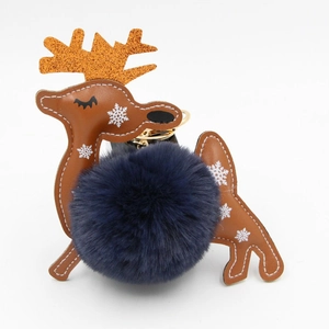 Detail of reindeer faux fur keychain with blue pompom and orange glitter antlers