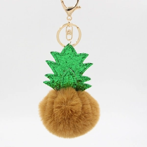 Detail of creative pineapple plush keychain with green sequins and brown faux fur puff
