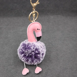 Détail du porte-clés flamant rose avec pompon en fourrure violette et fermoir doré