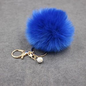 Royal blue faux fur pompom keychain with golden lobster clasp and sparkling rhinestone ball