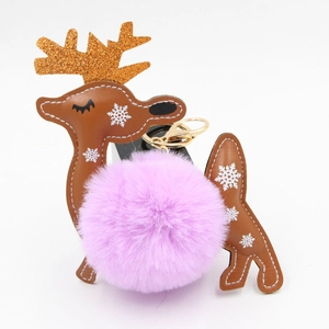 Close-up of reindeer leather charm with a purple fluffy pompom and gold glitter antlers
