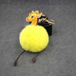 Plush giraffe pompom keychain with yellow faux fur and golden metal lobster clasp
